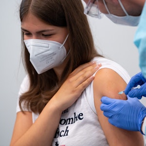 Eine Schülerin einer Abschlussklasse wird im Impfzentrum an der Messe München geimpft.