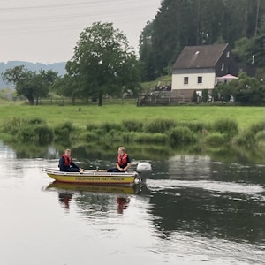Zwei Personen sitzen auf einen Rettungsboot auf der Ruhr.