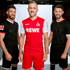 Die Profis Rafael Czichos (M.) sowie Salih Özcan (l.) und Mark Uth präsentieren das neue Auswärtstrikot in Rot und Weiß sowie das schwarze Ausweichdress des 1. FC Köln.
