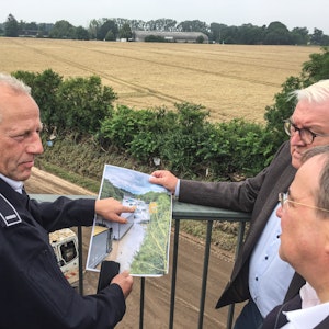Feuerwehrmann Udo Milewski (links) erklärt NRW-Ministerpräsident Armin Laschet (vorne) und Bundespräsident Frank-Walter Steinmeier an der B265 im Ortsteil Liblar die Situation nach der Flutkatastrophe.