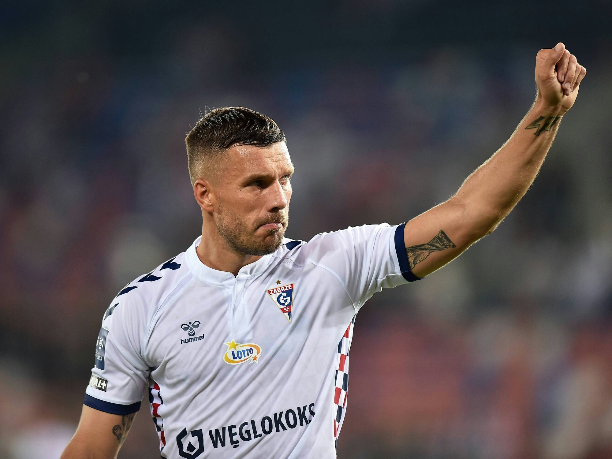 Lukas Podolski streckt die Faust in Richtung der Fans von Gornik Zabrze aus.