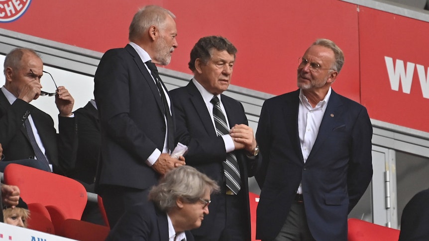Hermann Gerland, Otto Rehhagel und Karl-Heinz Rummenigge auf der Tribüne der Allianz Arena.