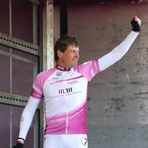 Jan Ullrich reckt am Rande eines Radrennens die Faust in die Luft.