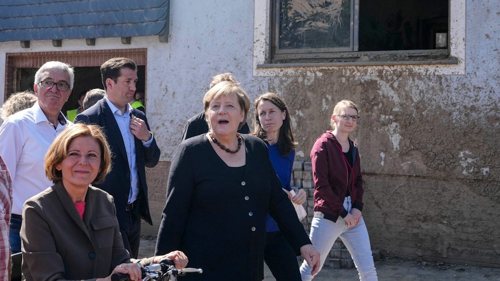 German Chancellor Angela Merkel, center, and Malu Dreyer, left, Prime Minister of Rhineland-Palatinate, talk to residents during their visit to the flood-damaged district Altenburg, part of the municipality of Altenahr, Germany, on September 3, 2021. - After days of extreme downpours, devastating floods hit the valley of the river Ahr in July 2021. (Photo by Markus Schreiber / POOL / AFP)