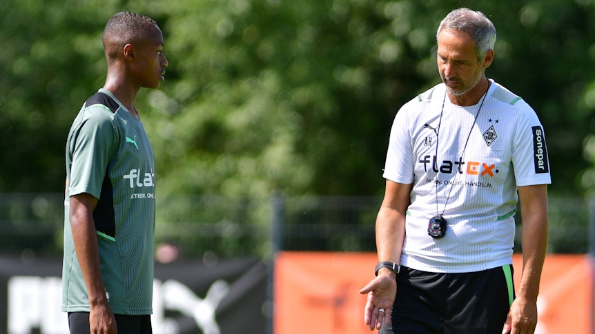Gladbach-Cheftrainer Adi Hütter (r.) am 18. Juli 2021 in Harsewinkel im Gespräch mit Borussias neuem Nationalspieler Yvandro Borges Sanches (l.).