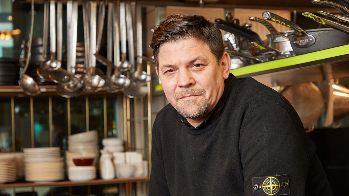 Fernsehkoch Tim Mälzer sitzt in der Küche seines Restaurants „"Die Gute Botschaft“".