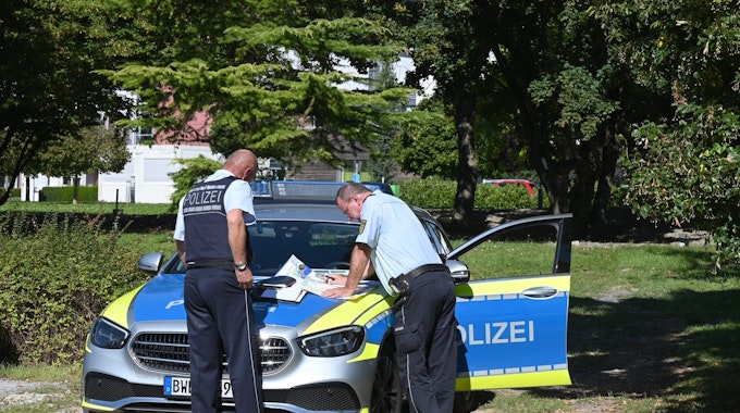 Polizisten besprechen sich vor der Klinik am Weissenhof in Weinsberg. Strafgefangene waren zuvor aus der Psychatrie ausgebrochen.