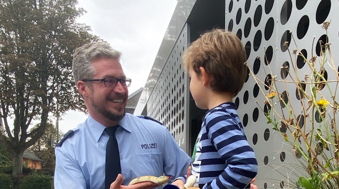 Polizeioberkommissar Patrick Schardt und der Sechsjährige bei der Spielzeugrückgabe.