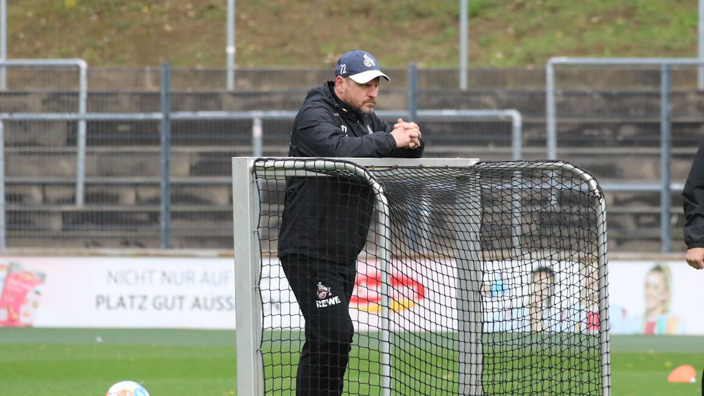 Steffen Baumgart lehnt sich im Training des 1. FC Köln auf ein kleines Fußballtor.