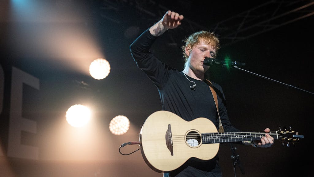 Ed Sheeran steht mit seiner Gitarre auf der Bühne.&nbsp;