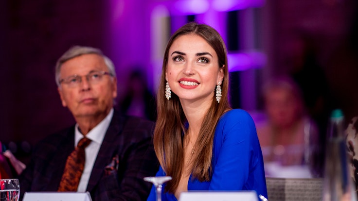 Ekaterina Leonova sits on the jury of the “Miss 50 plus” beauty contest and smiles.