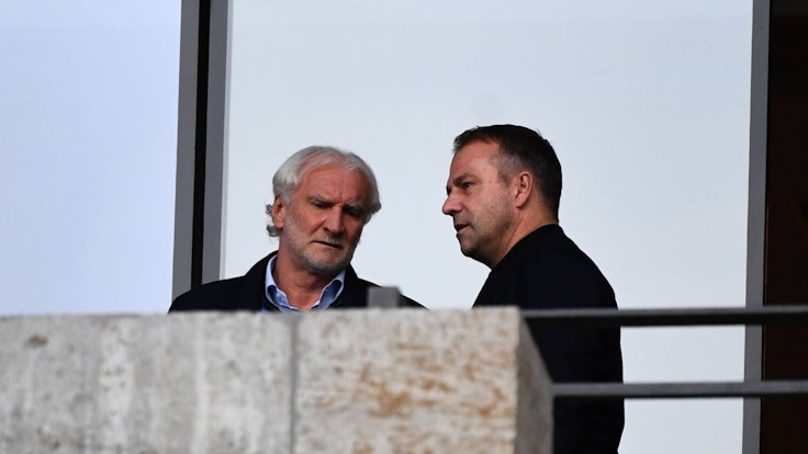 Bayer Leverkusens Geschäftsführer Rudi Völler spricht mit Bundestrainer Hansi Flick auf der Tribüne.