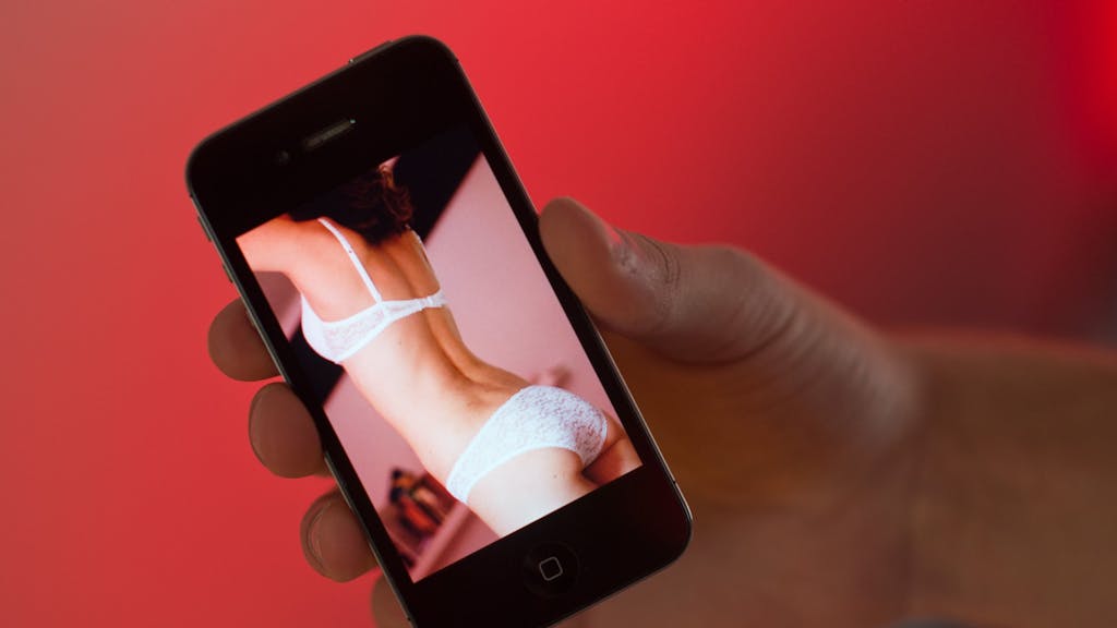 Immer wieder kommt es zu Vorfällen, in welchen Nacktfotos zur Erpressung genutzt werden. Auf dem Symbolfoto aufgenommen am 31. Oktober 2013) hält ein Mann ein Handy in der Hand, auf welchem das Foto einer Frau in Unterwäsche zu sehen ist.&nbsp;