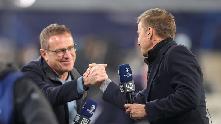 Leipzigs Trainer Jesse Marsch (r) und Leipzigs ehemaliger Trainer Ralf Rangnick schütteln nach einem Interview die Hand.