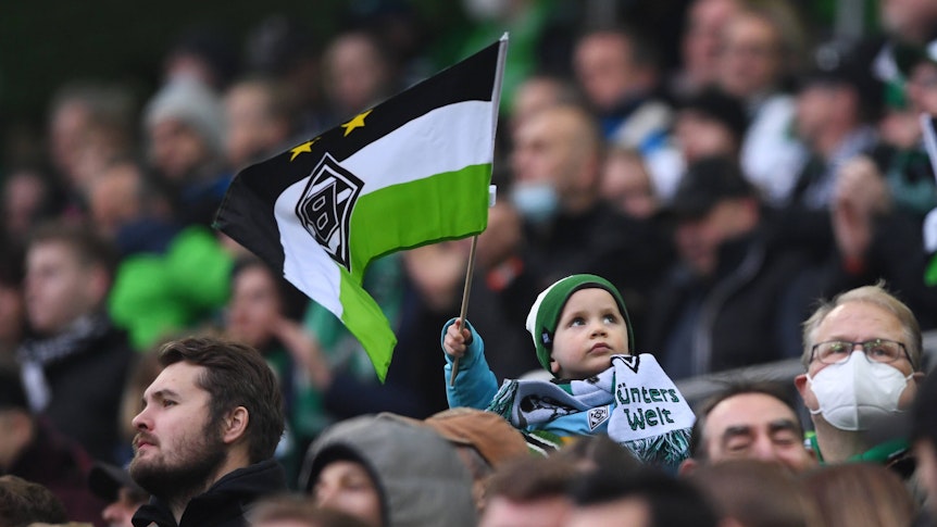 Fans und Zuschauer im Borussia-Park. Dieses Foto stammt vom 20. November 2021 und ist während des Bundesligaspiels von Borussia Mönchengladbach gegen Greuther Fürth entstanden. Ein Kind schwenkt eine Borussia-Fahne.
