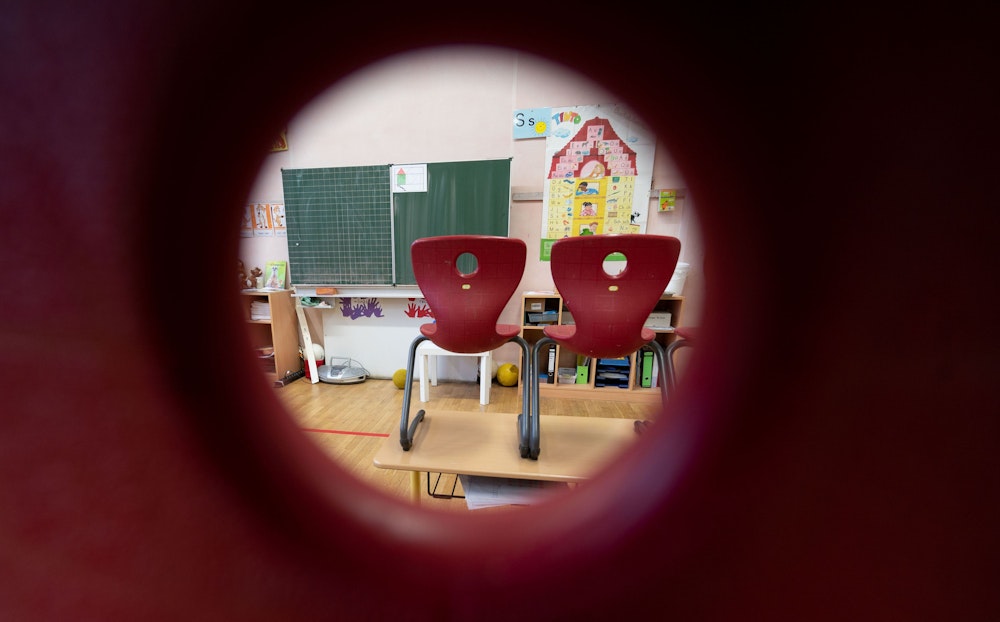 Stühle stehen in einem Klassenzimmer einer ersten Klasse der Marienschule in Stuttgart auf Tischen.