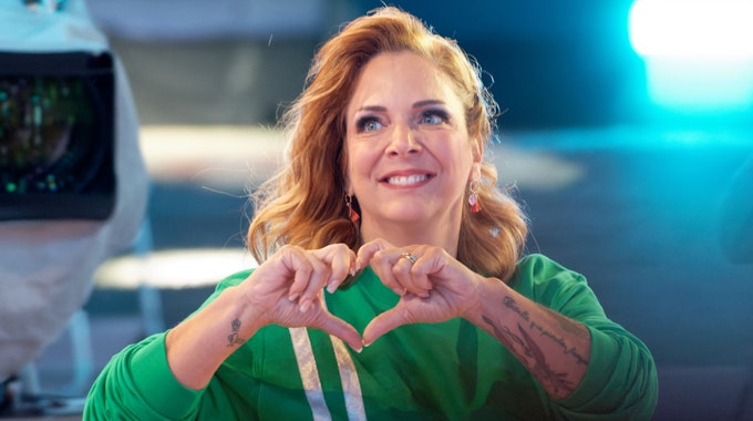 Die Teilnehmerin Danni Büchner zeigt bei der Auftaktsendung der Sat.1 Fernsehshow „Promi Big Brother 2021“ im Studio mit ihren Händen ein Herz.