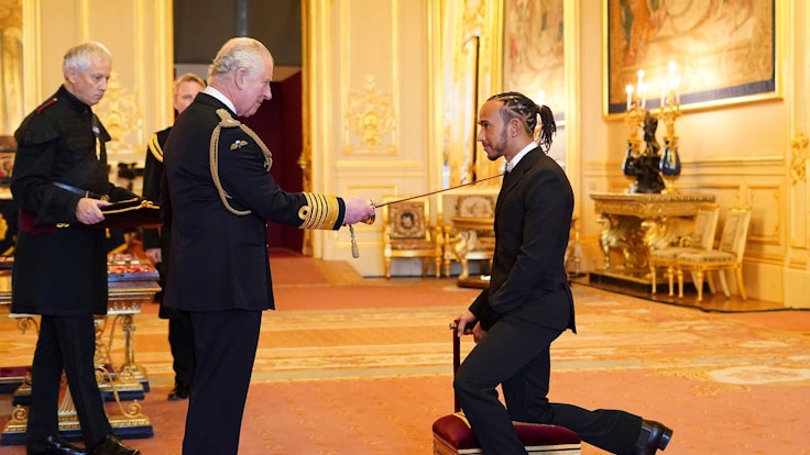 Lewis Hamilton is made a Knight Bachelor by Britain's Prince Charles at Windsor Castle, in Windsor, England, Wednesday, Dec. 15, 2021. (Dominic Lipinski/PA via AP)
