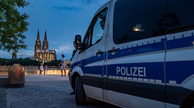 Ein Mannschaftswagen der Kölner Polizei steht während der andauernden Corona-Krise am Rheinboulevard im Kölner Stadtteil Deutz.