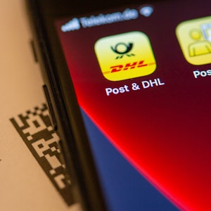 Das Logo der Post & DHL App ist auf dem Display eines Smartphones zu sehen. Das Symbolbild wurde am 5. Dezember 2021 aufgenommen.