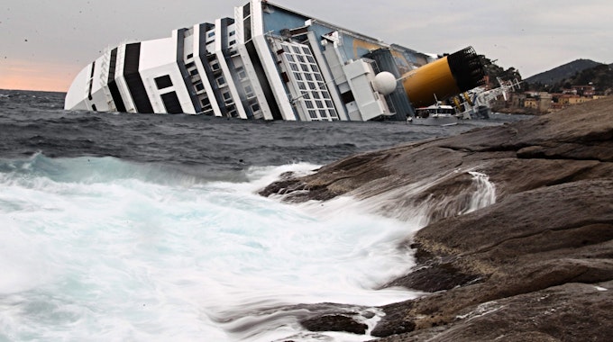 A file picture dated 16 January 2012 shows waves crashing against the rocks as the Costa Concordia Cruise ship lists off the coast of the island of Giglio, Itlay. On 15 October 2012 experts are due to present their findings at a pre-trial hearing dealing with the case of the capsized Italian cruise ship Costa Concordia, in Grosseto, Italy.&nbsp;