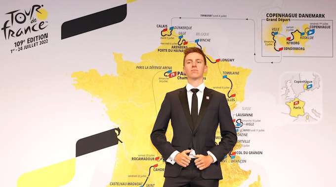 Tadej Pogacar vor einem Plakat mit der neuen Route der Tour de France 2022 in Paris.