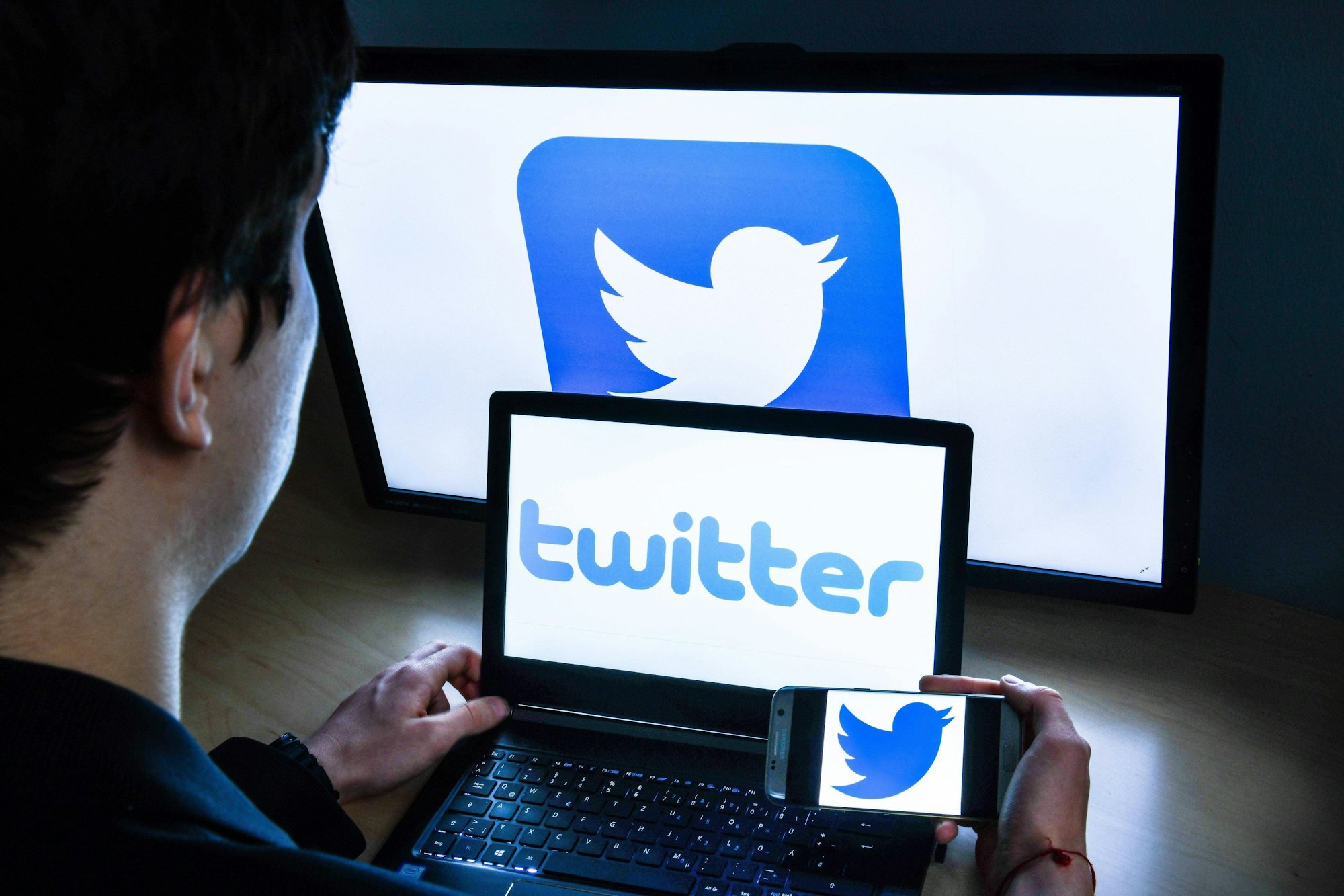Ein Mann sitzt vor einem Laptop und hat die Twitter-App gestartet