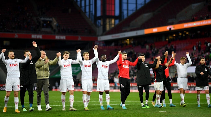Die Spieler des 1. FC Köln feiern den Sieg gegen den SC Freiburg vor der Kurve.