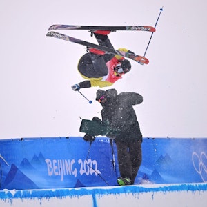 Der Finne Jon Sallinen kracht in der Halfpipe-Qualifikation im Genting Snow Park von Zhangjiakou am 17. Februar 2022 bei einem Sprung mit voller Wucht in einen Kameramann.