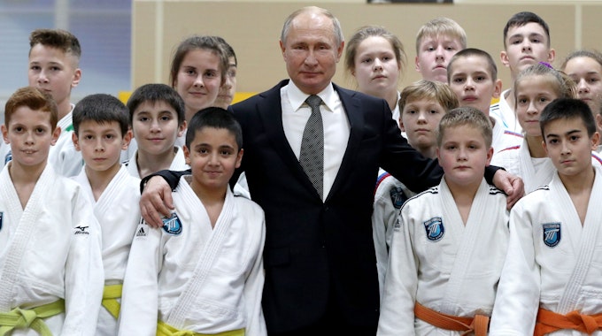 Wladimir Putin posiert mit Judo-Sportlern.