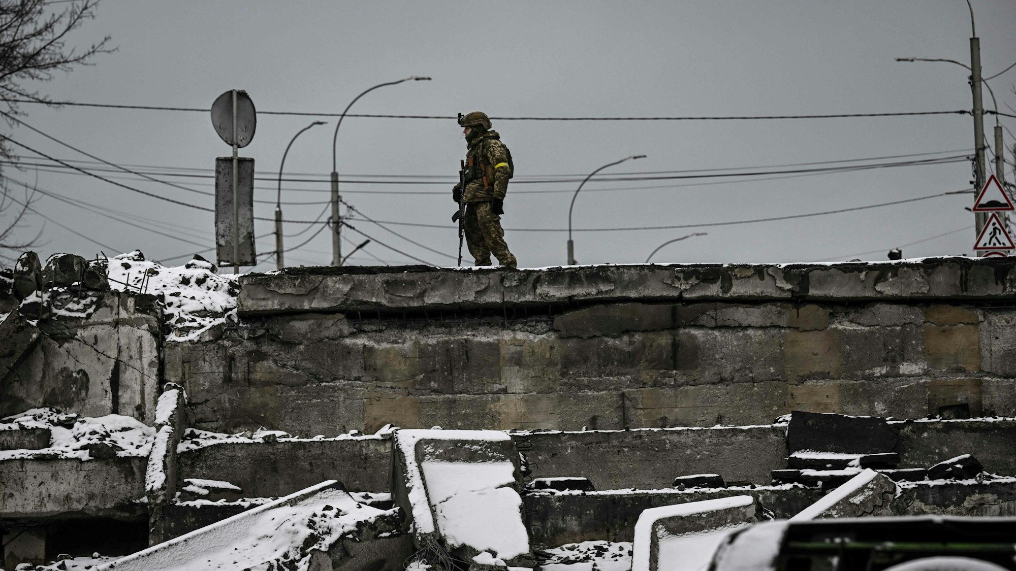 Ein ukrainischer Soldat patrouilliert auf einer zerstörten Brücke im Norden von Kiew am Dienstag (1. März).