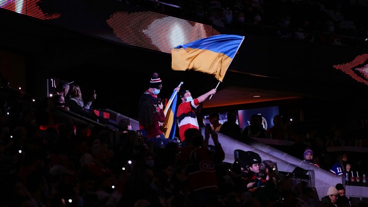 Ein Fan schwenkt eine Flagge der Ukraine während des NHL-Spiels zwischen den Ottawa Senators und den Montreal Canadiens.