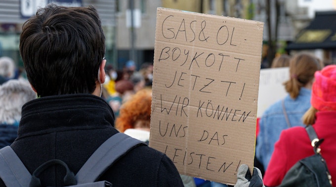 Ein Teilnehmer hält bei einer Demonstration von Fridays for Future gegen den Krieg in der Ukraine ein Schild mit Aufschrift «Gas und Öl Boykott jetzt! Wir können uns das Leisten».