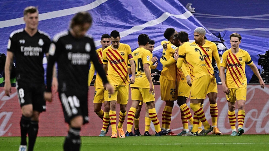 Die Spieler des FC Barcelona jubeln, im Vordergrund laufen Toni Kroos und Luka Modric