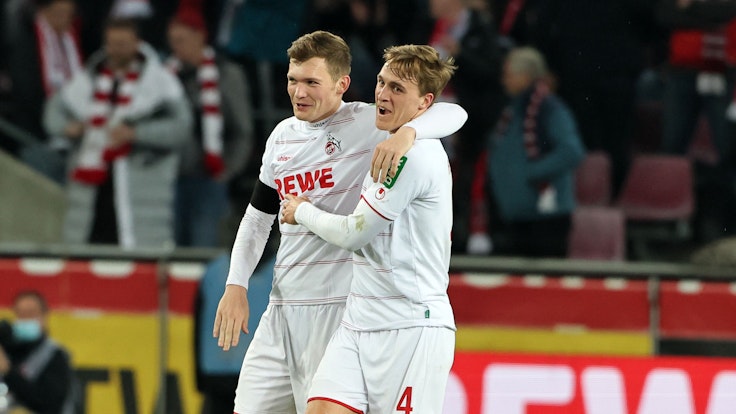 Luca Kilian und Timo Hübers umarmen sich nach dem 1:1 des 1. FC Köln gegen Borussia Dortmund.