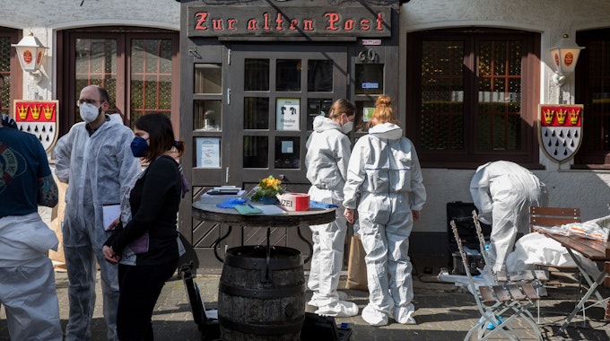 Ermittler der Spurensicherung stehen vor der Kölner Gaststätte „Zur alten Post“.