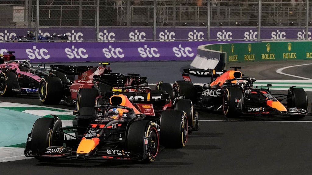 Red Bull driver Sergio Perez of Mexico leads at the start of the Formula One Grand Prix it in Jiddah, Saudi Arabia, Sunday, March 27, 2022. (AP Photo/Hassan Ammar)
