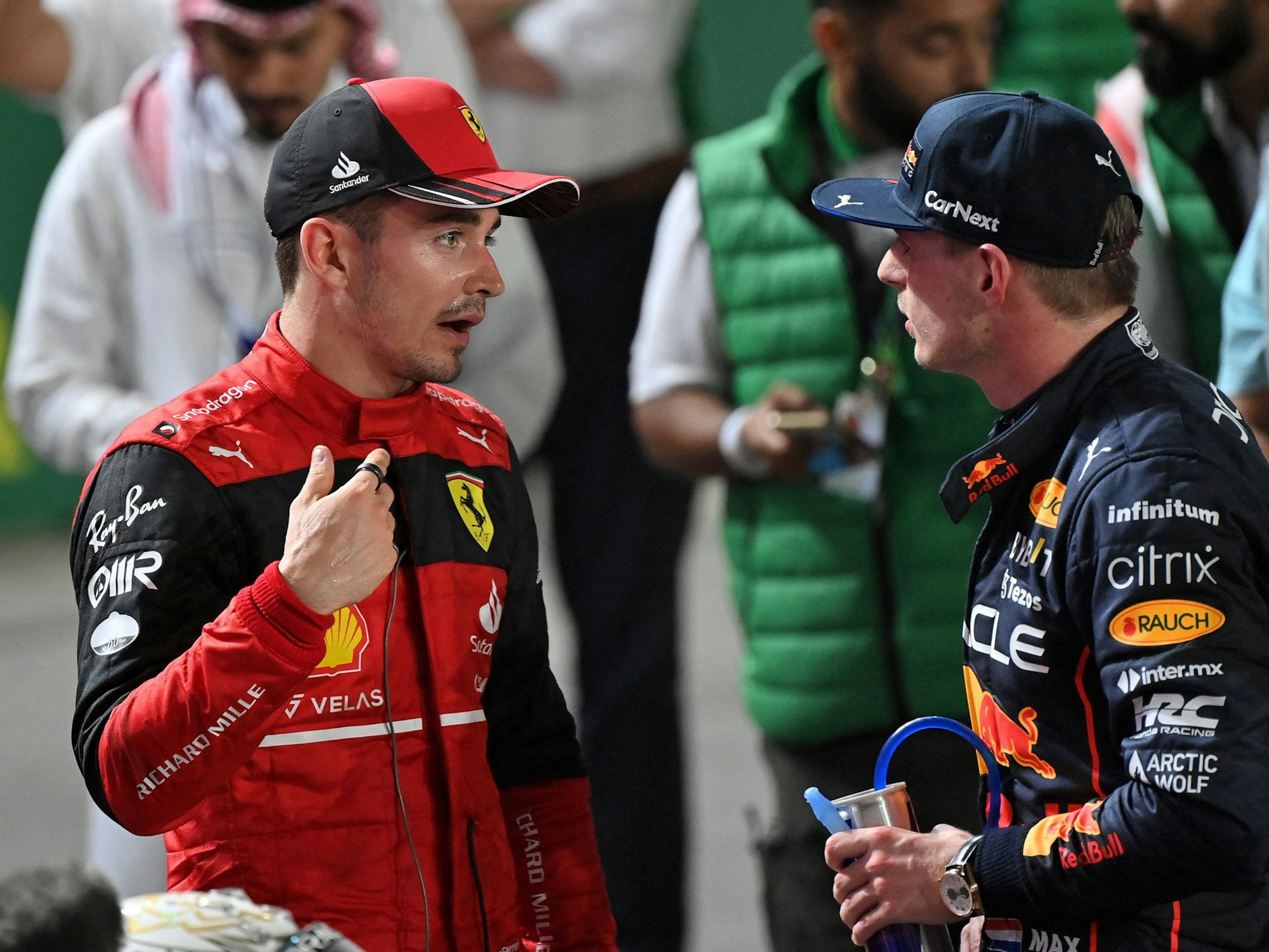 Ferrari's Monegasque driver Charles Leclerc (L) chats with Red Bull's Dutch driver Max Verstappen (R) after the 2022 Saudi Arabia Formula One Grand Prix at the Jeddah Corniche Circuit on March 27, 2022. (Photo by ANDREJ ISAKOVIC / AFP)