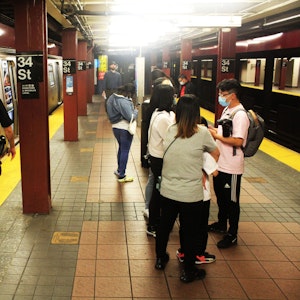 Das undatierte Symbolfoto zeigt eine U-Bahn-Station mit zwei haltenden Bahnen und mehreren Menschen, darunter ein Polizist in Uniform.
