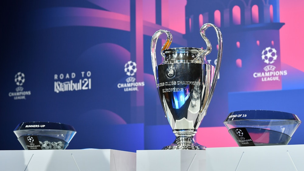 Fußball: UEFA Champions League, Auslosung - K.o.-Runde, Achtelfinale. Der Champions-League-Pokal steht neben den Lostöpfen auf einem Podest.