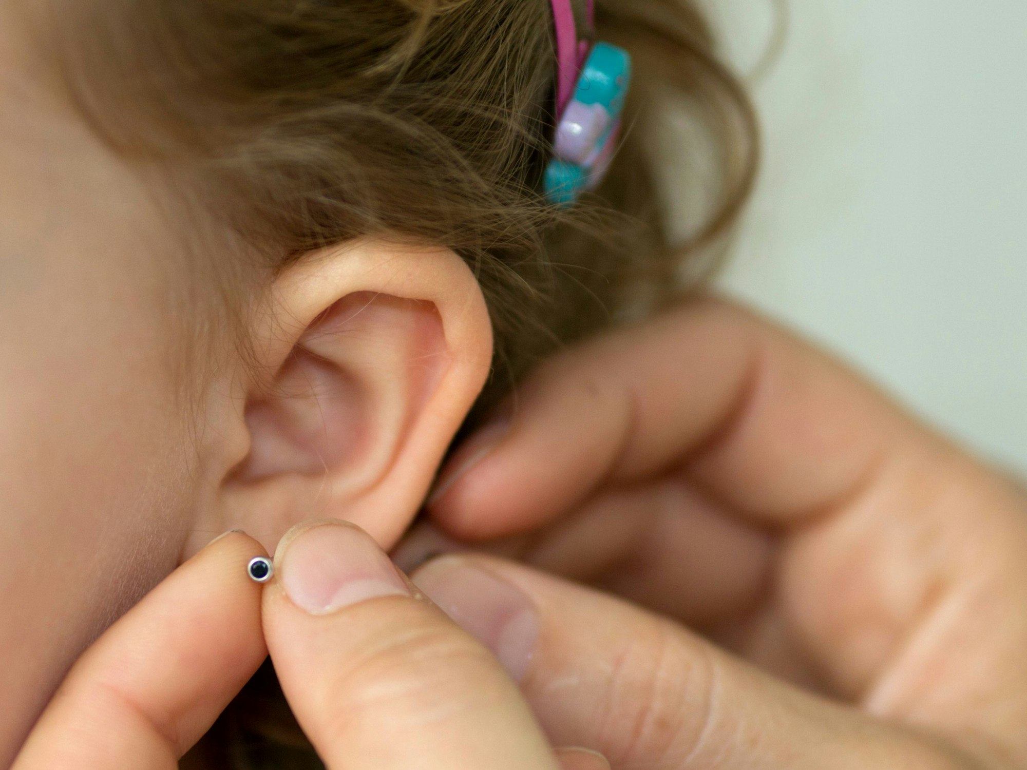Rückruf von Schmuck: Bei bestimmten Ohrringen ist jetzt Vorsicht geboten. Sie können schlimme allergische Reaktionen auslösen. Unser Symbolbild zeigt Ohrringe bei einem Kind.