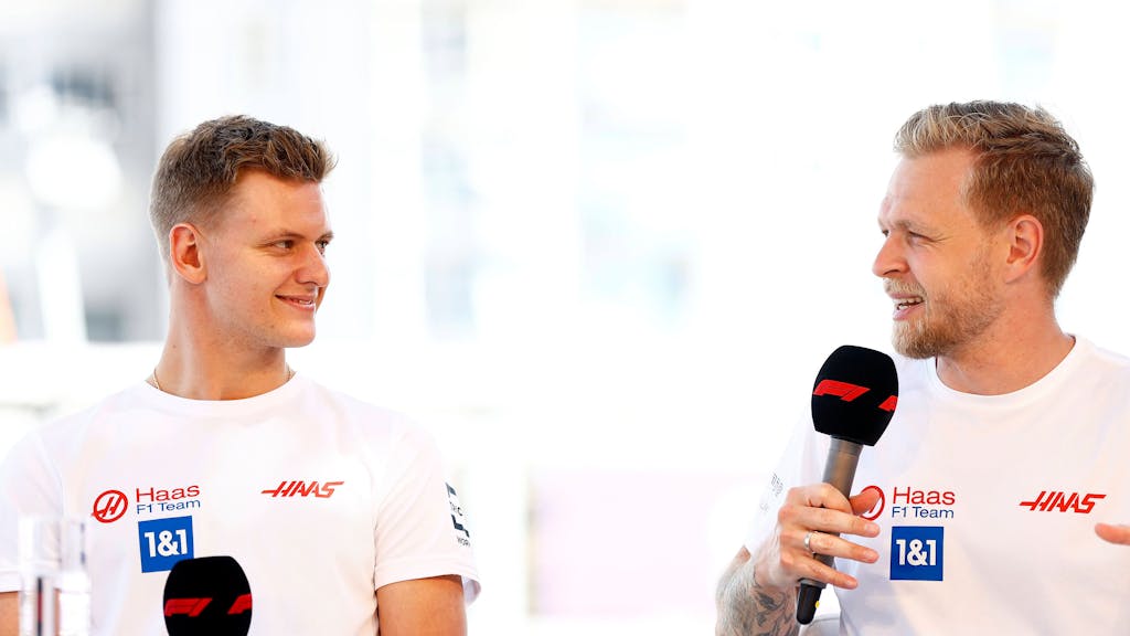 Mick Schumacher (links) und Kevin Magnussen schauen sich während eines Interviews an.