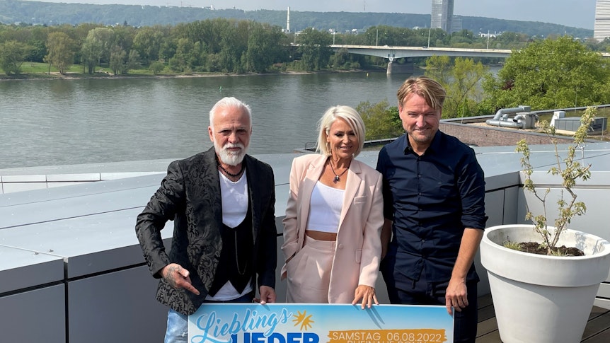 Nino de Angelo, Michelle und Veranstalter Markus Krampe posieren am Rhein.