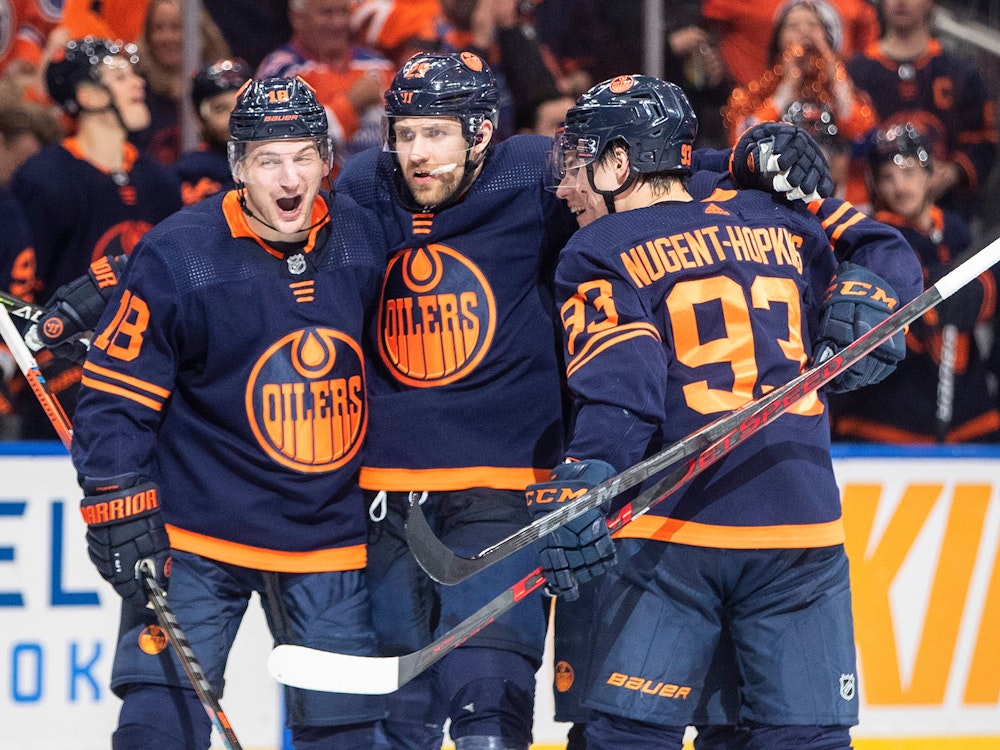 Edmonton Oilers' Zach Hyman (18), Leon Draisaitl (29) and Ryan Nugent-Hopkins (93) celebrate a goal against the Los Angeles Kings during the second period of Game 2 of an NHL hockey Stanley Cup playoffs first-round series Wednesday, May 4, 2022, in Edmonton, Alberta. (Jason Franson/The Canadian Press via AP)