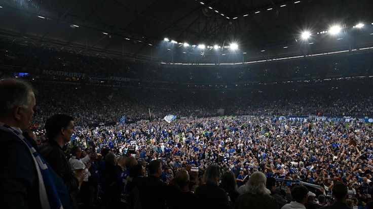 Mehrere Tausend Fans von Schalke 04 stürmen bei den Aufstiegs-Feierlichkeiten den Rasen der Veltins-Arena.