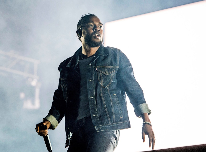 Kendrick Lamar mit Mikrofon auf einer Konzertbühne.
