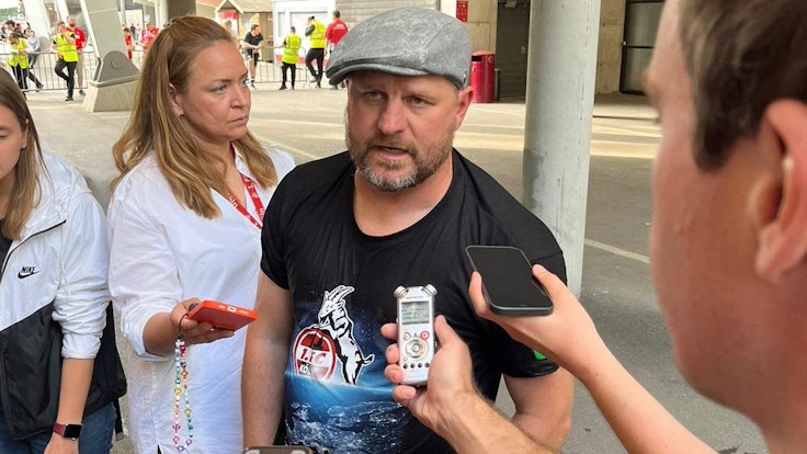 Steffen Baumgart gibt im Europa-Shirt des 1. FC Köln Interviews. Die Mixed-Zone in Stuttgart wurde wegen der VfB-Feierlichkeiten kurzerhand nach draußen verlegt.