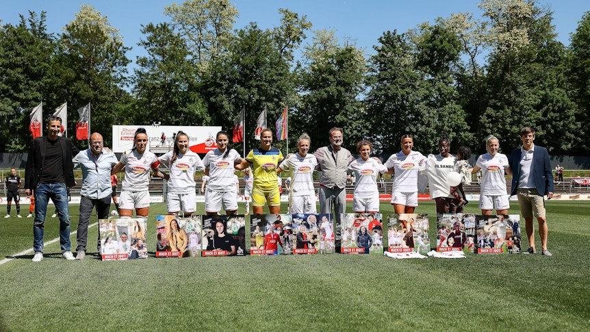 Neun Spielerinnen des 1. FC Köln werden mit Erinnerungsstücken auf dem Rasen verabschiedet.