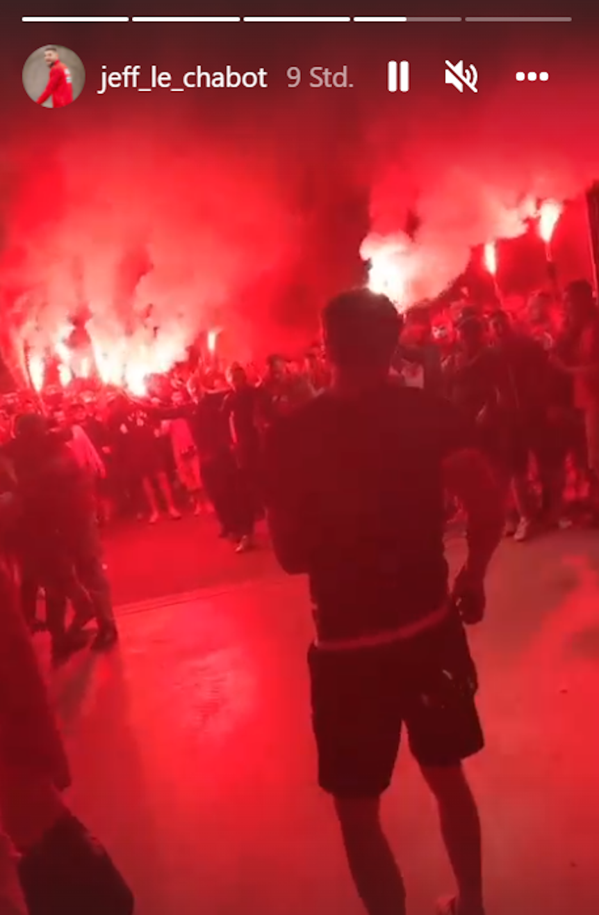 Die Profis des 1. FC Köln laufen auf ihre Fans zu, die am Stadion mit Pyrotechnik feiern.