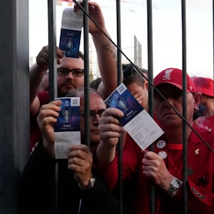 Liverpool-Fans zeigen ihre Eintrittskarten und warten vor dem Stade de France.